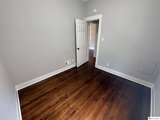 1322 S 21st St, Omaha, NE 68108 - spare room featuring baseboards, dark wood-style floors, and a smoke detector