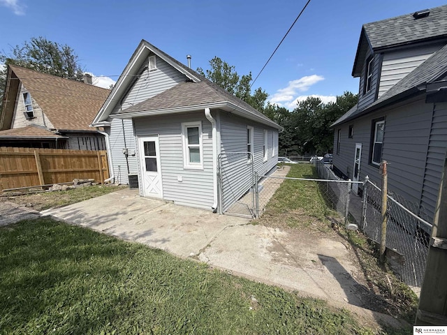 1322 S 21st St, Omaha, NE 68108 - back of house with a patio area and a shingled roof