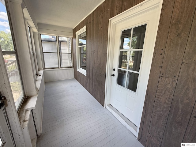 1322 S 21st St, Omaha, NE 68108 - unfurnished sunroom with wood walls and hardwood / wood-style floors