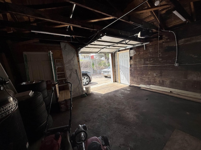 1322 S 21st St, Omaha, NE 68108 - garage featuring a garage door opener and wooden walls