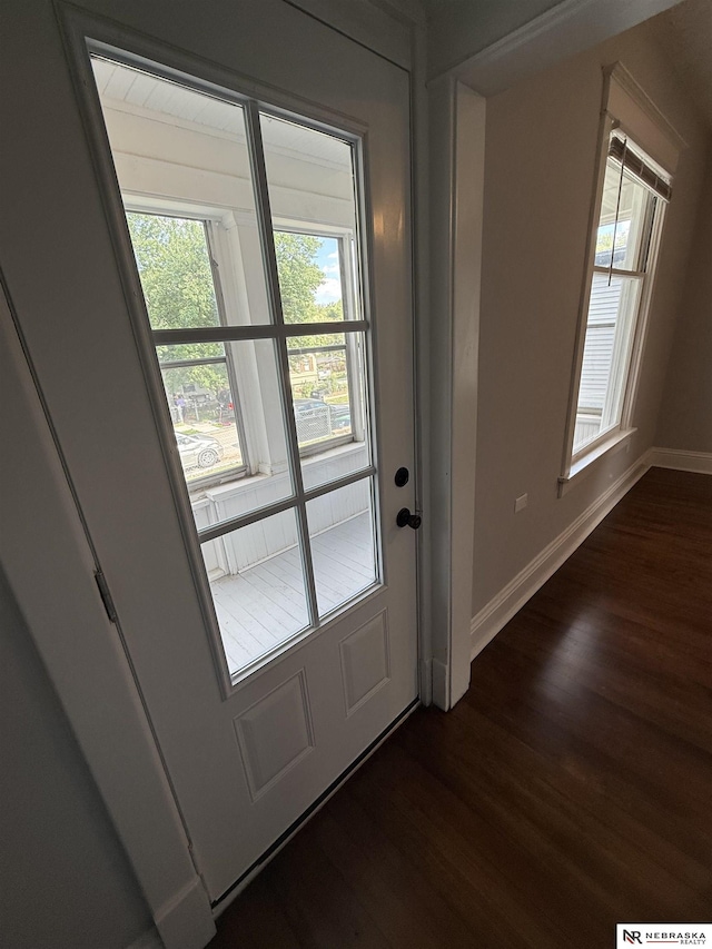 1322 S 21st St, Omaha, NE 68108 - doorway with dark wood-type flooring and baseboards