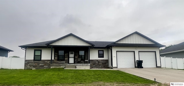 1001 Trail Dr, Valentine, NE 69201 - view of front facade with a garage, stone siding, driveway, and board and batten siding