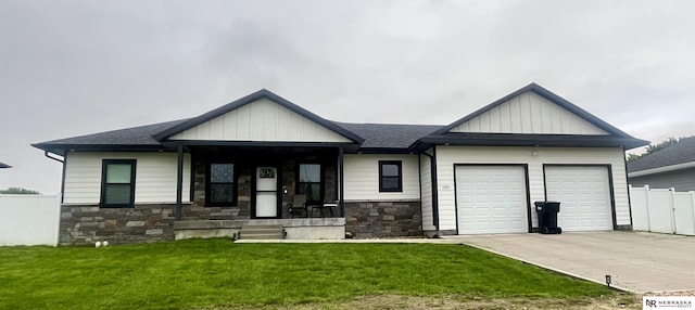 1001 Trail Dr, Valentine, NE 69201 - view of front of house featuring an attached garage, stone siding, concrete driveway, and board and batten siding