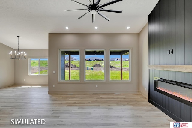 9350 S 86th St, Lincoln, NE 68526 - unfurnished living room with light wood-style flooring, a chandelier, a large fireplace, baseboards, and recessed lighting