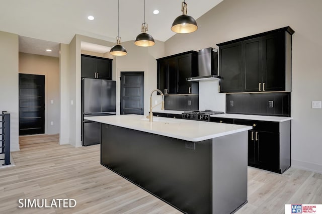 9350 S 86th St, Lincoln, NE 68526 - kitchen featuring freestanding refrigerator, wall chimney range hood, dark cabinets, a sink, and recessed lighting