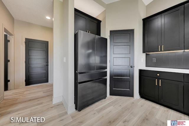 9350 S 86th St, Lincoln, NE 68526 - kitchen with freestanding refrigerator, light wood-style floors, dark cabinetry, baseboards, and recessed lighting