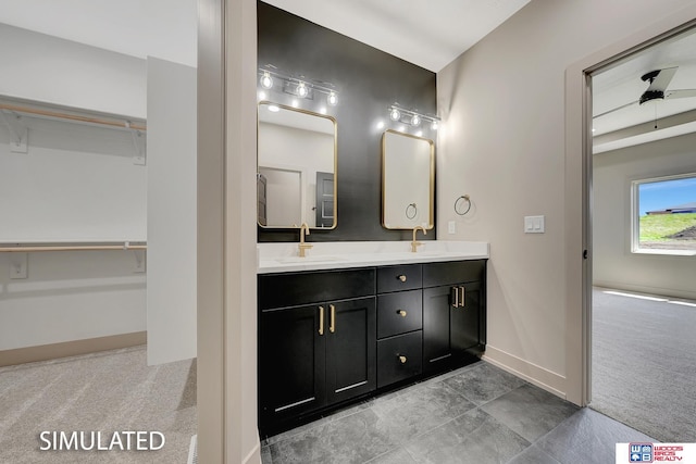 9350 S 86th St, Lincoln, NE 68526 - bathroom featuring double vanity, baseboards, and a walk in closet