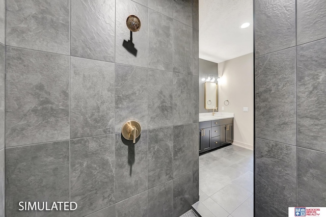 9350 S 86th St, Lincoln, NE 68526 - bathroom with a tile shower, vanity, tile patterned floors, and baseboards
