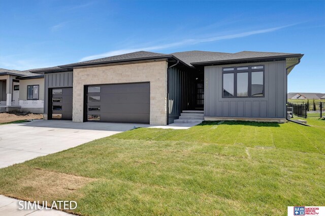9350 S 86th St, Lincoln, NE 68526 - view of front of house with board and batten siding, an attached garage, driveway, and a front yard