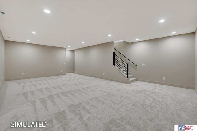 9350 S 86th St, Lincoln, NE 68526 - finished below grade area with light carpet, stairway, recessed lighting, and baseboards