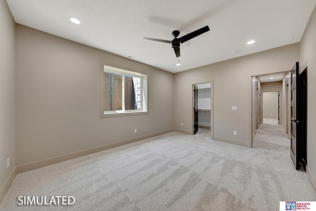 9350 S 86th St, Lincoln, NE 68526 - unfurnished bedroom with light carpet, recessed lighting, a walk in closet, baseboards, and ceiling fan
