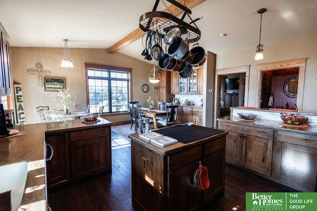 3860 Shady Bend Rd, Grand Island, NE 68801 - kitchen featuring dark wood-type flooring, hanging light fixtures, dark brown cabinetry, and a peninsula