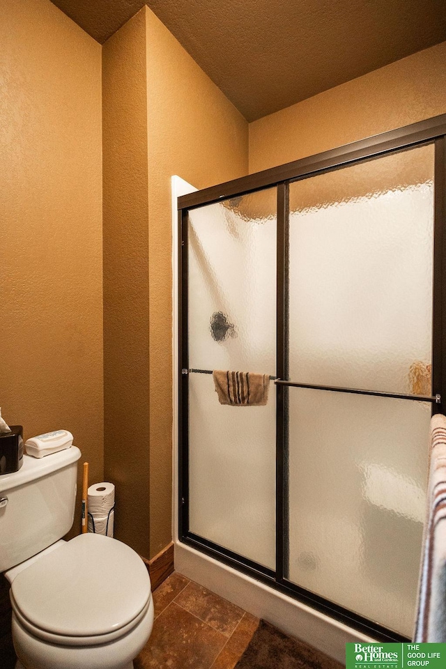 3860 Shady Bend Rd, Grand Island, NE 68801 - full bath with a shower stall, a textured wall, toilet, and baseboards
