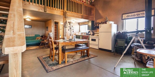 3860 Shady Bend Rd, Grand Island, NE 68801 - dining space featuring finished concrete flooring and a high ceiling