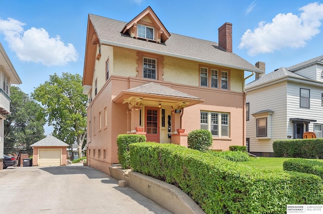 115 N 38th Ave, Omaha, NE 68131 - american foursquare style home featuring a detached garage, brick siding, an outbuilding, and a chimney