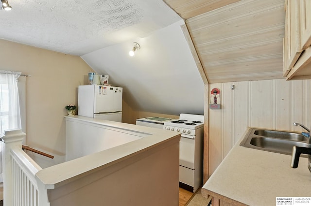 115 N 38th Ave, Omaha, NE 68131 - kitchen featuring white appliances, lofted ceiling, and light countertops