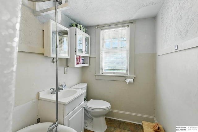 115 N 38th Ave, Omaha, NE 68131 - bathroom with vanity, stone finish flooring, and a textured ceiling