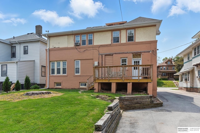 115 N 38th Ave, Omaha, NE 68131 - back of property with a yard, a wooden deck, stucco siding, and brick siding