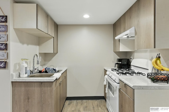 115 N 38th Ave, Omaha, NE 68131 - kitchen featuring gas range gas stove, under cabinet range hood, light wood finished floors, light countertops, and recessed lighting