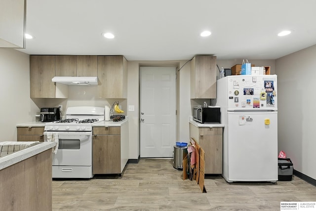 115 N 38th Ave, Omaha, NE 68131 - kitchen featuring white appliances, under cabinet range hood, light countertops, light wood-style flooring, and recessed lighting