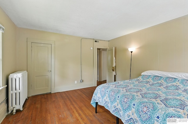 115 N 38th Ave, Omaha, NE 68131 - bedroom featuring radiator heating unit and wood finished floors