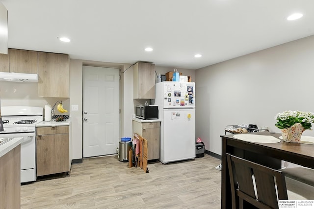 115 N 38th Ave, Omaha, NE 68131 - kitchen with white appliances, extractor fan, light countertops, light wood-style floors, and recessed lighting