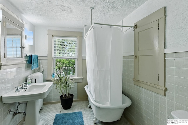 115 N 38th Ave, Omaha, NE 68131 - full bath featuring tile walls, radiator, a freestanding bath, a shower with shower curtain, and wainscoting