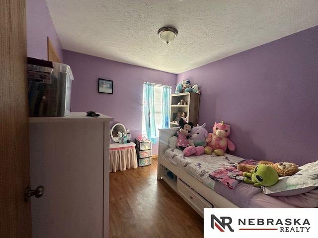 1703 Manderson St, Omaha, NE 68110 - bedroom featuring wood finished floors and a textured ceiling
