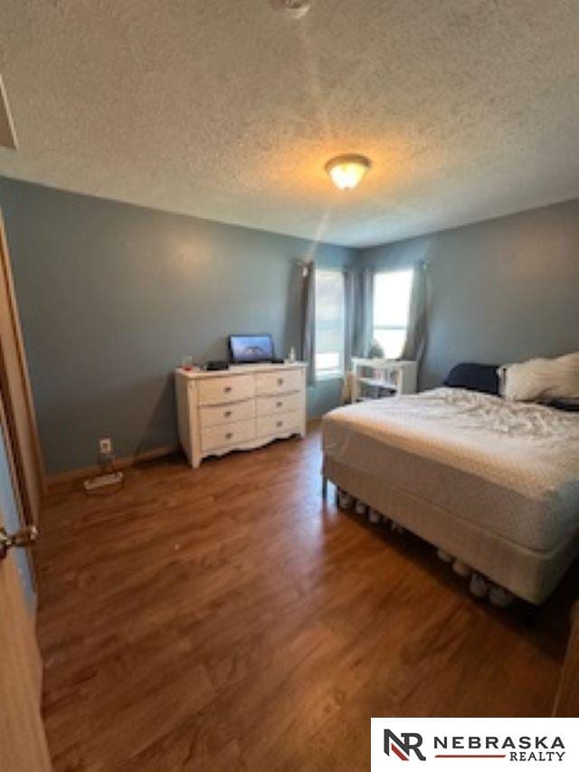 1703 Manderson St, Omaha, NE 68110 - bedroom with wood finished floors and a textured ceiling