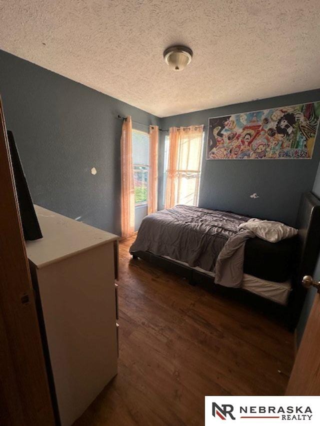 1703 Manderson St, Omaha, NE 68110 - bedroom featuring a textured ceiling and wood finished floors