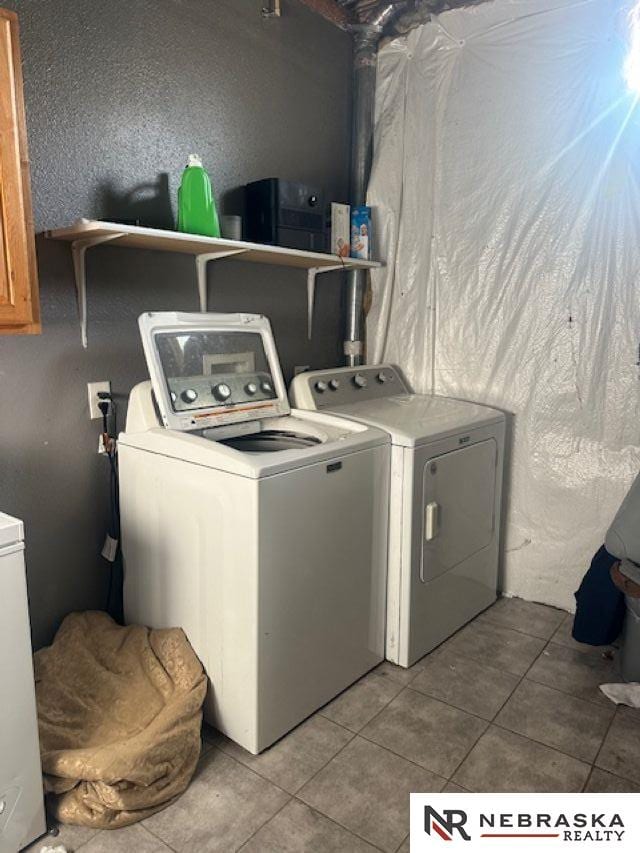 1703 Manderson St, Omaha, NE 68110 - laundry room with independent washer and dryer and tile patterned flooring