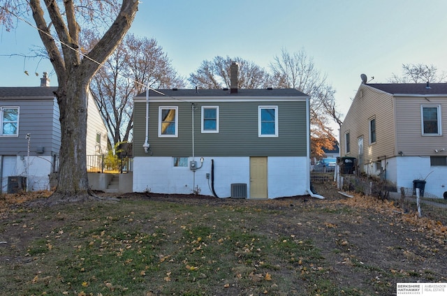 3948 N 54th St, Omaha, NE 68104 - back of house featuring central AC unit and a chimney