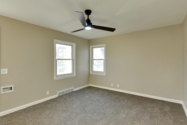 3948 N 54th St, Omaha, NE 68104 - empty room featuring a ceiling fan, dark carpet, and baseboards