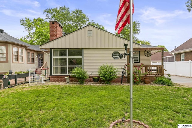 2026 N Park Ave, Fremont, NE 68025 - rear view of property featuring a chimney and a wooden deck