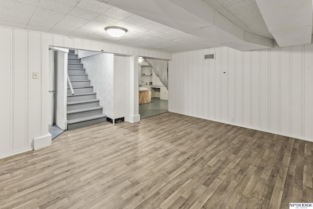 2026 N Park Ave, Fremont, NE 68025 - finished below grade area featuring wood finished floors, stairway, a drop ceiling, a decorative wall, and baseboards