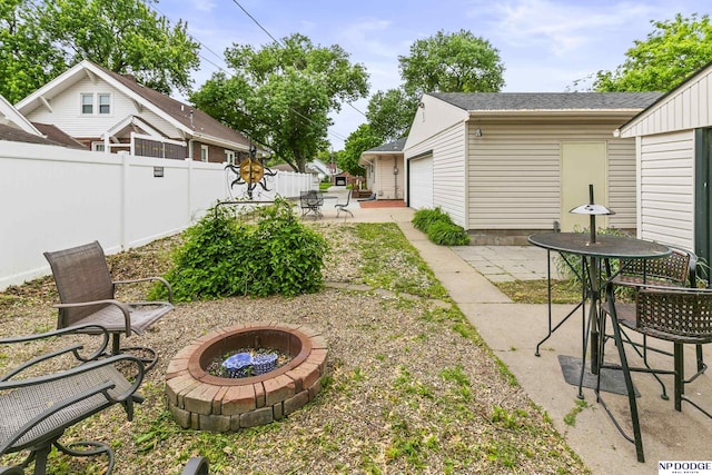 2026 N Park Ave, Fremont, NE 68025 - view of yard featuring a fire pit, a patio, an outdoor structure, a garage, and outdoor dining area