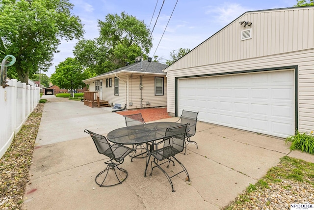 2026 N Park Ave, Fremont, NE 68025 - view of patio featuring a garage and outdoor dining space