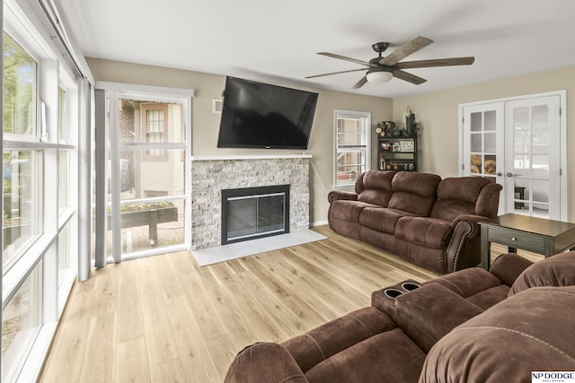 2026 N Park Ave, Fremont, NE 68025 - living room with a ceiling fan, a stone fireplace, wood finished floors, and french doors