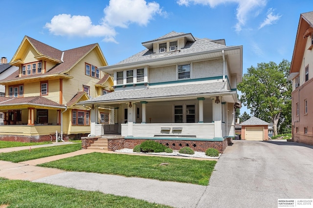 121 N 38th Ave, Omaha, NE 68131 - american foursquare style home featuring a porch, a detached garage, an outdoor structure, a front yard, and a shingled roof
