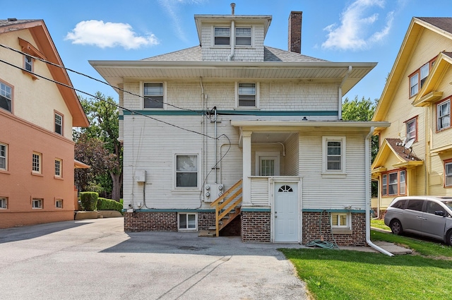 121 N 38th Ave, Omaha, NE 68131 - view of front of house featuring a chimney, a shingled roof, and a front yard