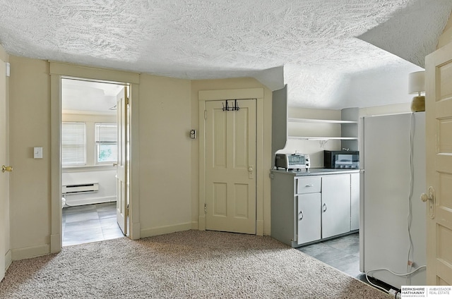 121 N 38th Ave, Omaha, NE 68131 - hallway with a baseboard heating unit, light carpet, and a textured ceiling
