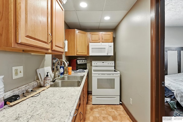 121 N 38th Ave, Omaha, NE 68131 - kitchen with white appliances, light brown cabinetry, recessed lighting, and a paneled ceiling