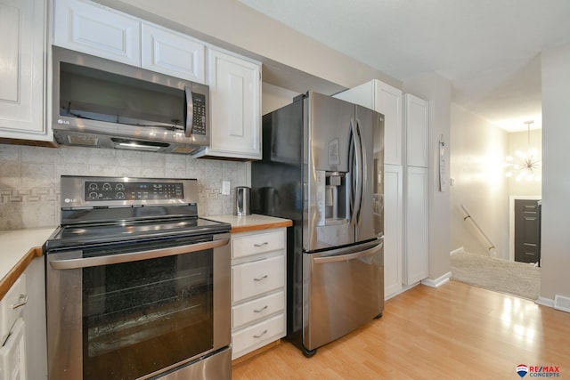 2430 Jameson St S, Lincoln, NE 68512 - kitchen with appliances with stainless steel finishes, white cabinets, light countertops, and light wood-style flooring