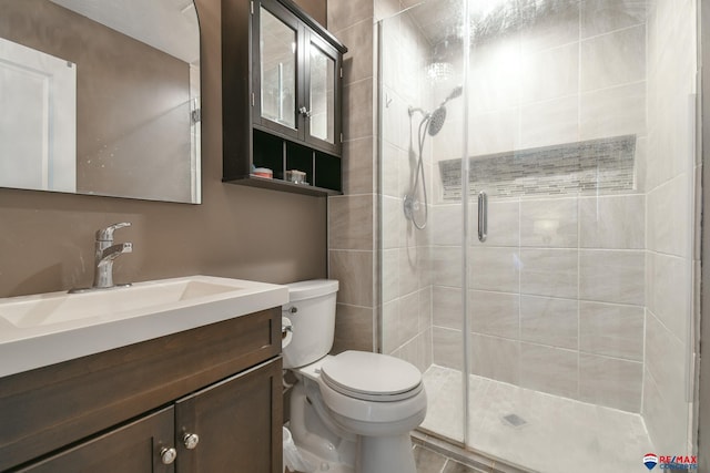 2430 Jameson St S, Lincoln, NE 68512 - bathroom featuring toilet, a stall shower, and vanity