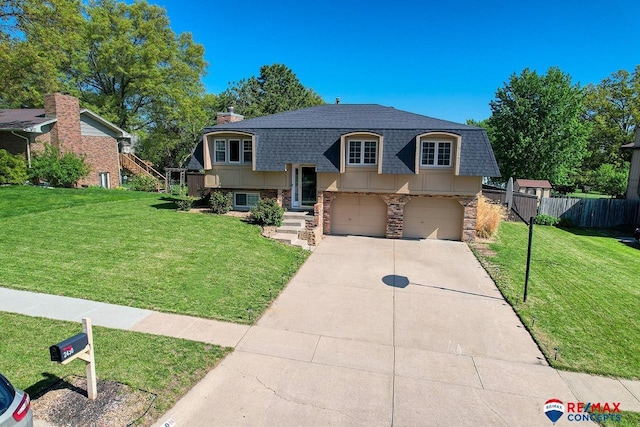 2430 Jameson St S, Lincoln, NE 68512 - bi-level home featuring roof with shingles, an attached garage, driveway, a chimney, and stone siding