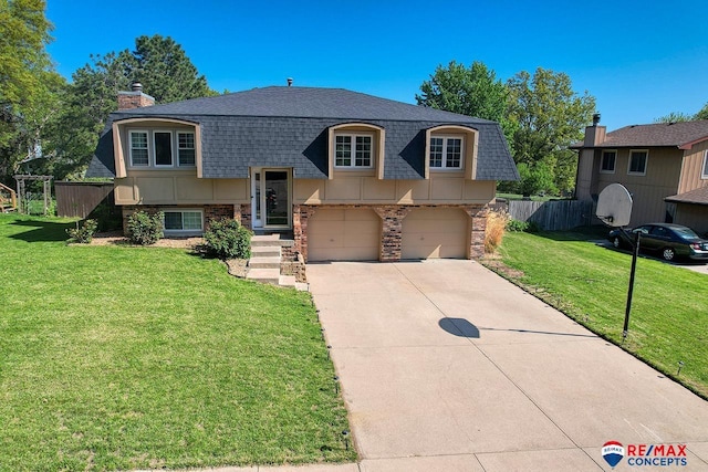 2430 Jameson St S, Lincoln, NE 68512 - bi-level home with a shingled roof, a garage, concrete driveway, a chimney, and mansard roof