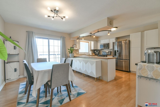 2430 Jameson St S, Lincoln, NE 68512 - dining space featuring a chandelier and light wood-style flooring