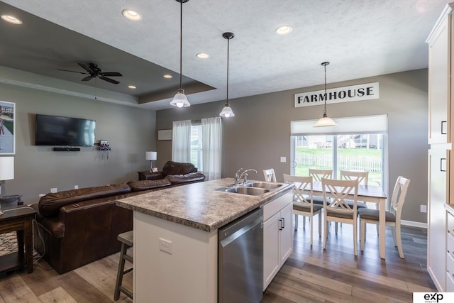 5614 N 177th St, Omaha, NE 68116 - kitchen with stainless steel dishwasher, a sink, open floor plan, wood finished floors, and recessed lighting