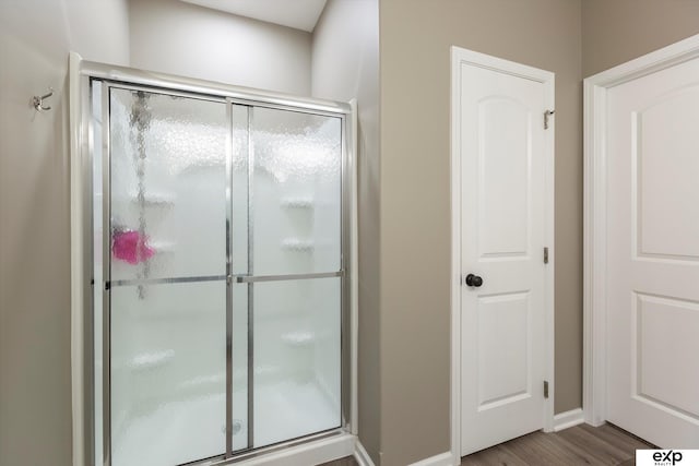 5614 N 177th St, Omaha, NE 68116 - full bathroom featuring a stall shower, wood finished floors, and baseboards