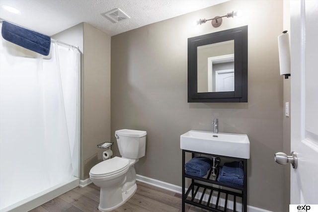 5614 N 177th St, Omaha, NE 68116 - full bathroom with toilet, wood finished floors, a textured ceiling, curtained shower, and baseboards